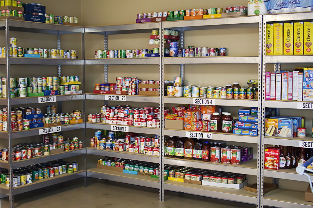 A large metal shelving unit filled with stored food and ingredients.
