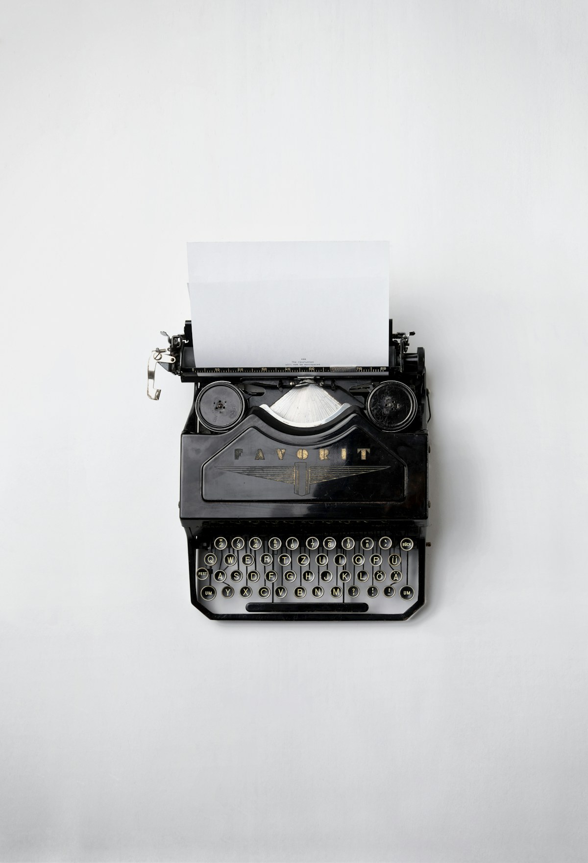 A vintage typewriter with a sheet of typed paper.