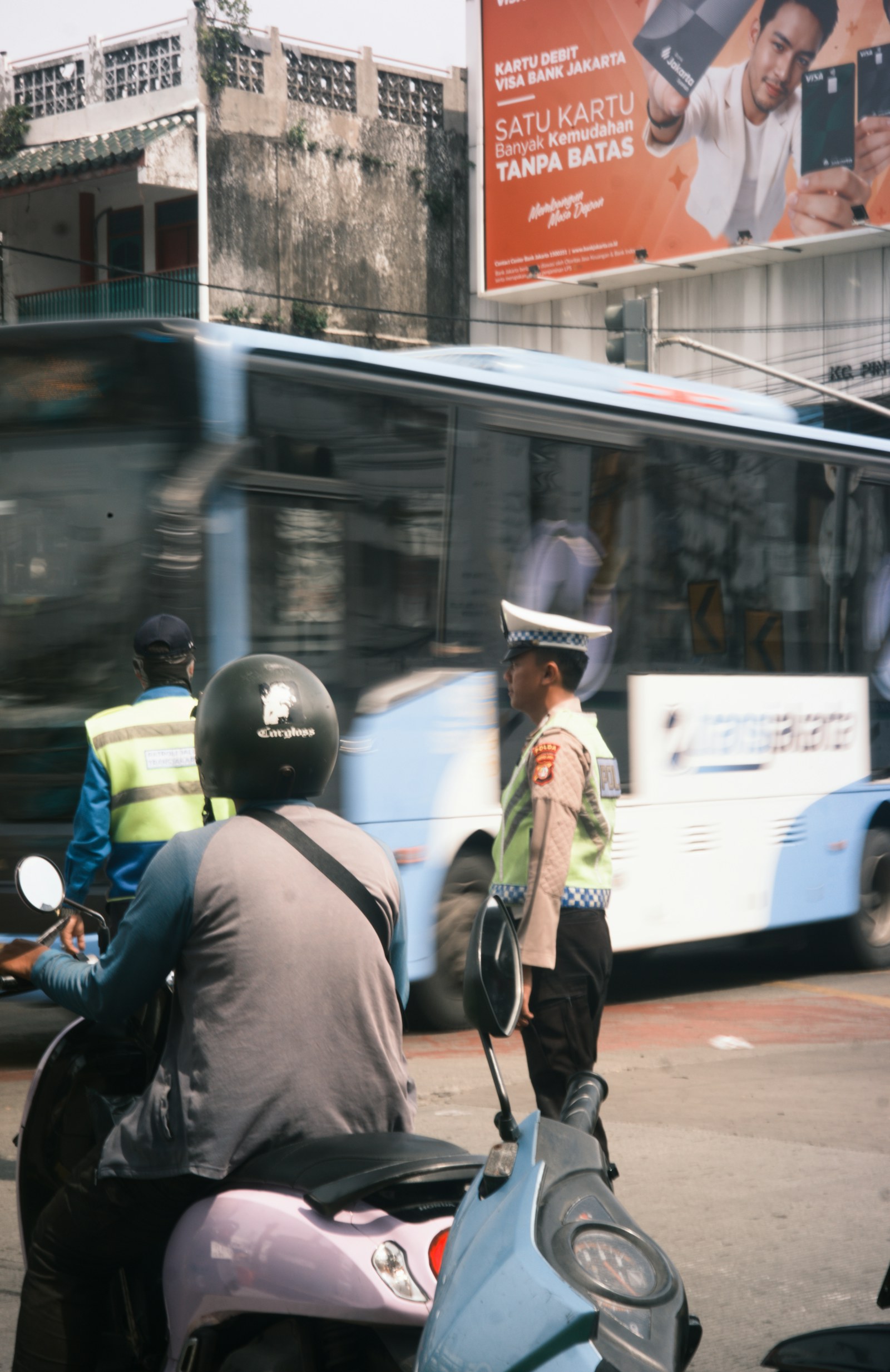 A traffic police officer directing busy traffic at a road intersection.