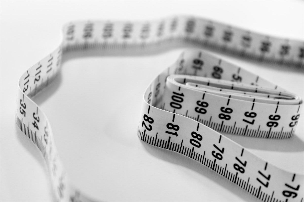 A close-up of a measuring tape with markings.