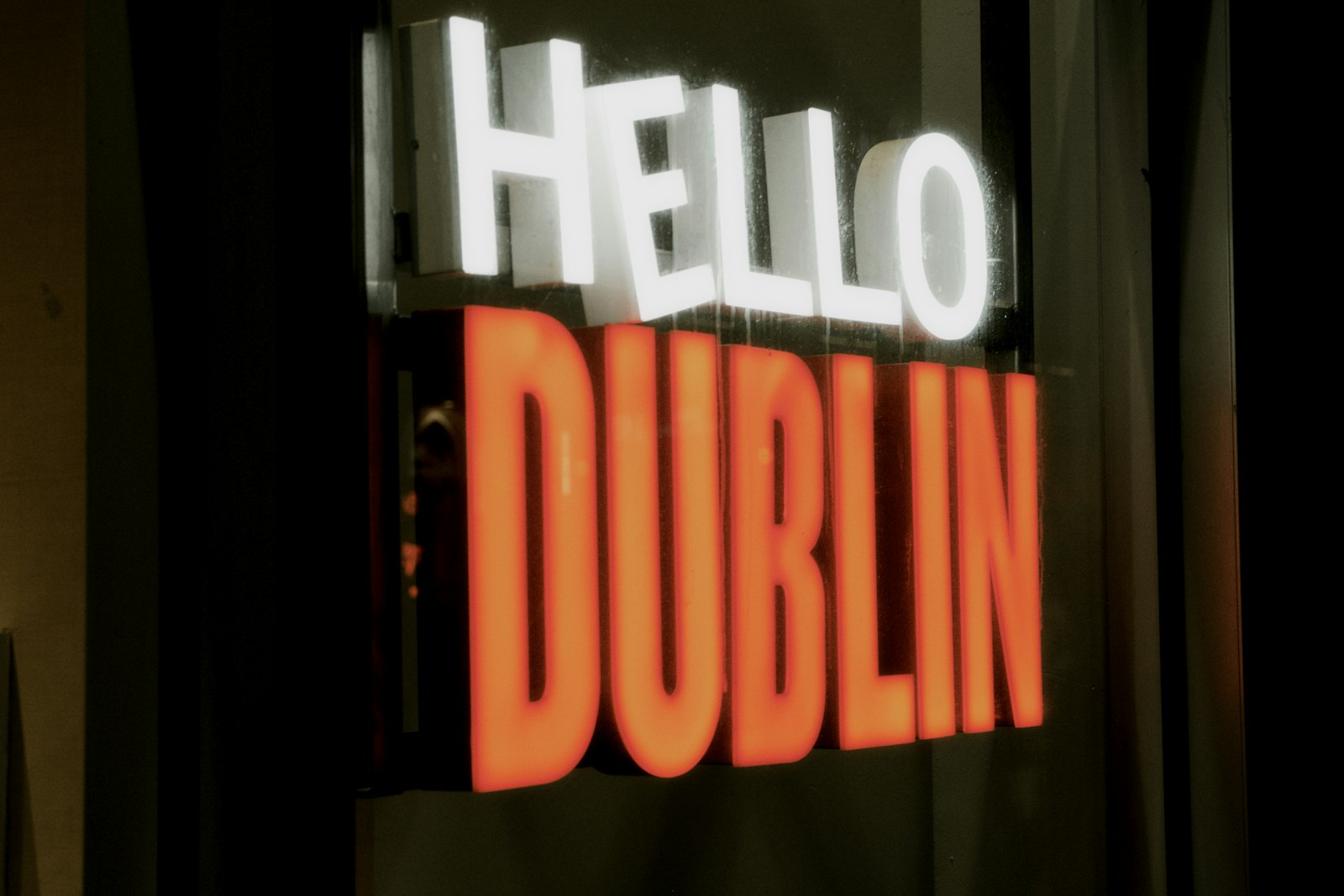 An illuminated 'hello' sign on a wall.