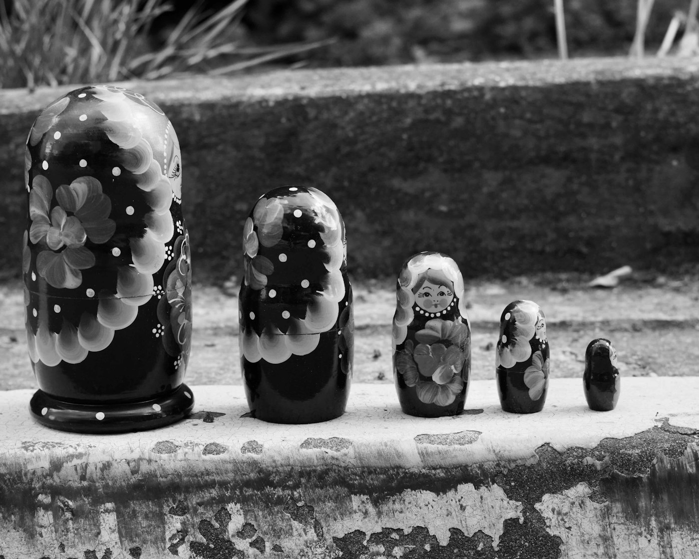 A row of Russian matryoshka nesting dolls, increasing in size.